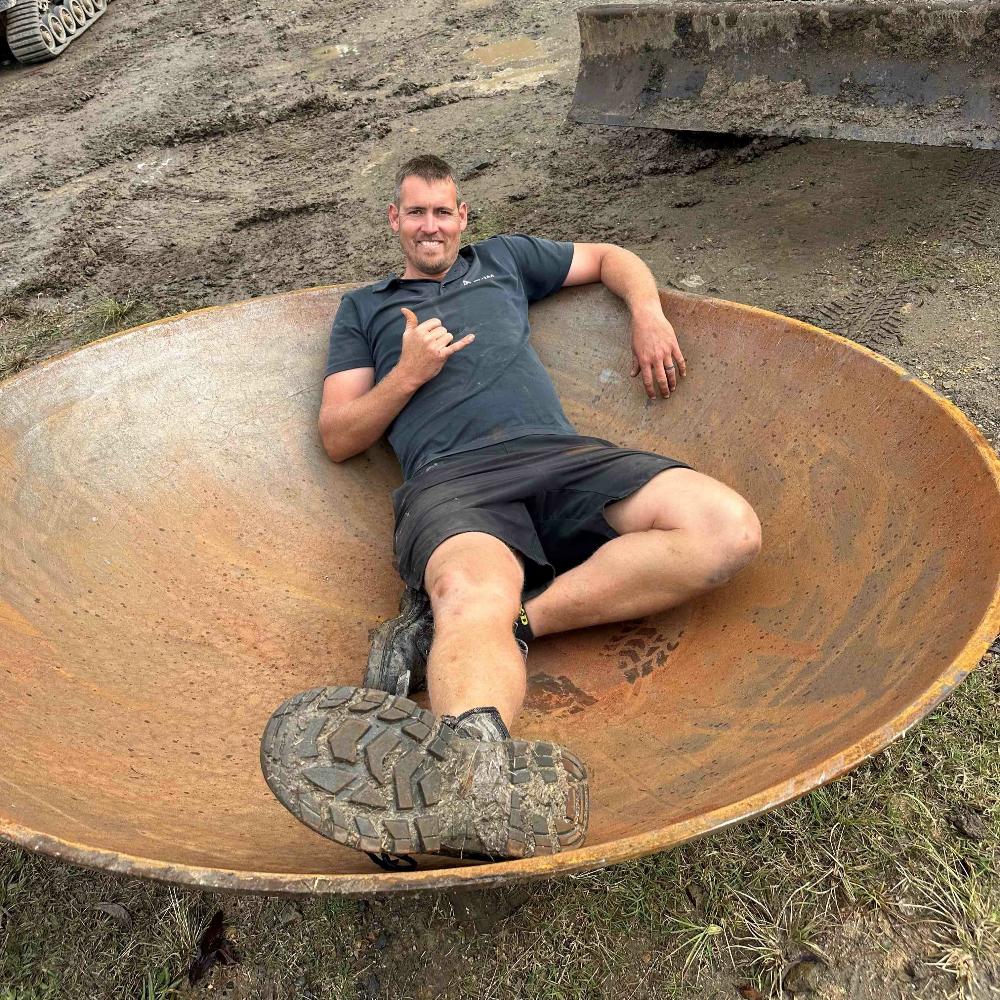 Young man relaxing inside the Crucible Fire Pit - Hot Fire Pits Australia