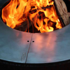 Fire burning in fire pit with a round centred Ringgrill BBQ Grill Plate