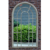 Tracey Garden Window Mirror on brick wall with hedges in reflection