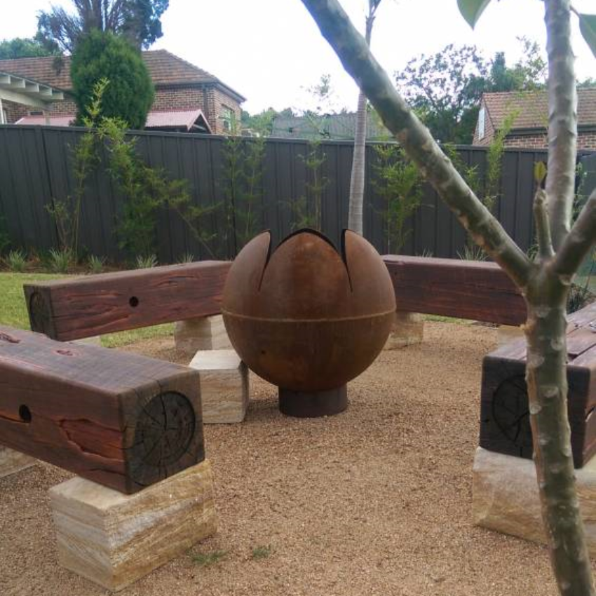 The Lotus Fire Pit in a nice back yard setting