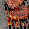 BBQ steaks cooking on a Yagoona Barramundi BBQ Grill Australia