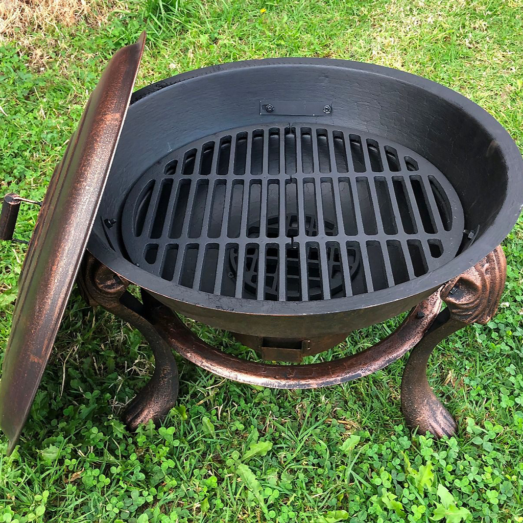 Top view of Vesuvius Firepit BBQ with Lid and grilling rack on a lawn