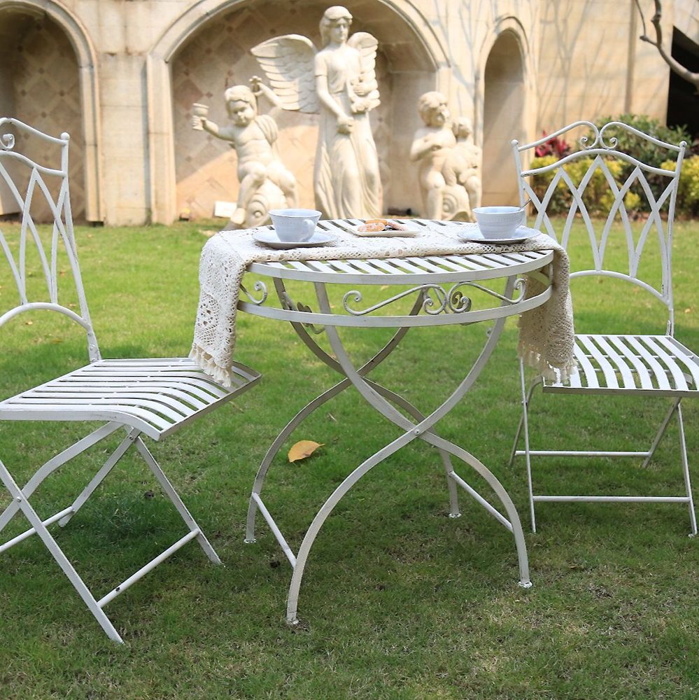 White coloured Albany 3 Piece Wrought Iron Setting in a garden setting