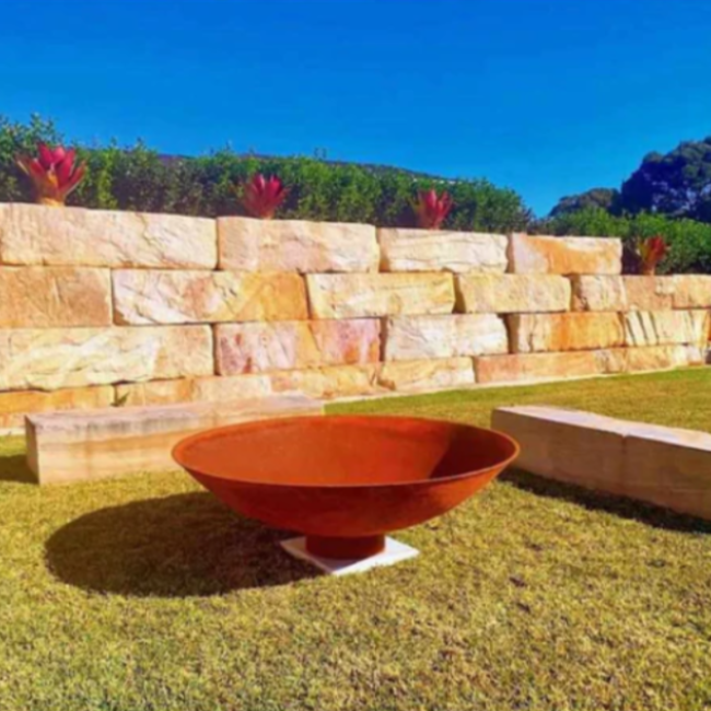  The Cauldron Fire Pit 1500mm in garden setting with large stone bench seats 