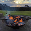 The Cauldron Fire Pit in Rust 1500mm with fire burning