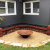 The Cauldron Cast Iron Fire Pit in outdoor setting