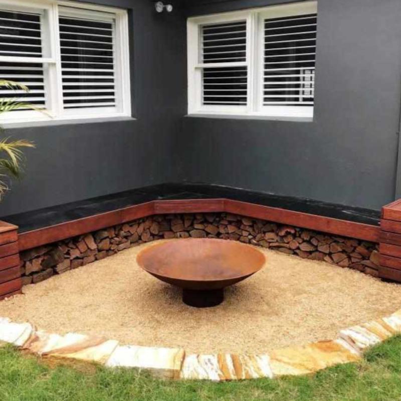 The Cauldron Cast Iron Fire Pit in outdoor setting