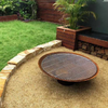 Cauldron 800mm Fire Pit in outdoor setting with BBQ grill