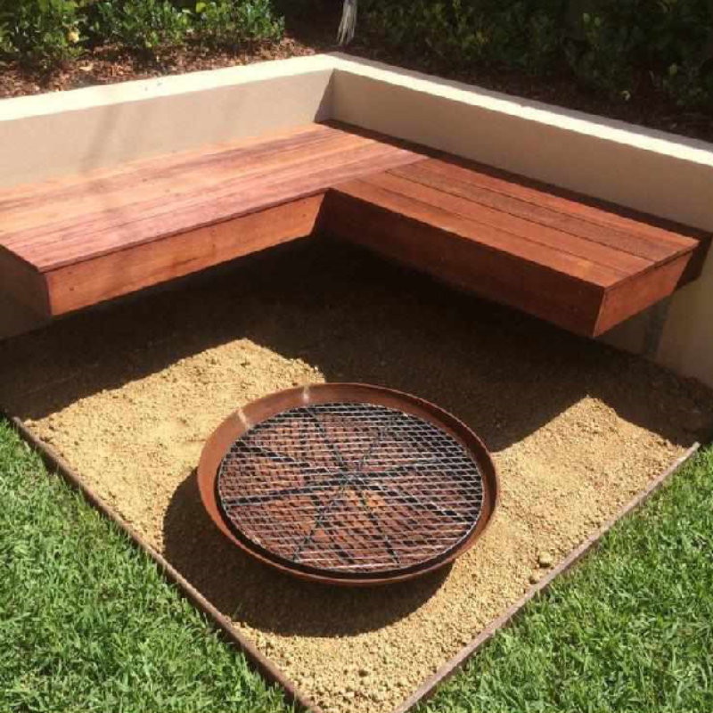 Cauldron Cast Iron Fire Pit and metal grill in an outdoor area