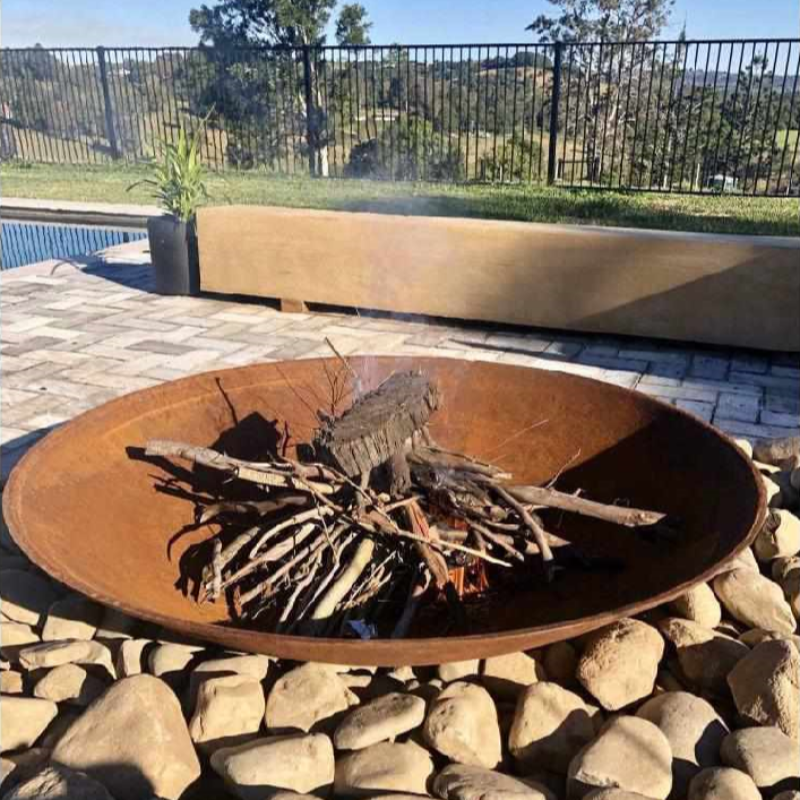 Cauldron 80cm Fire Pit in an outdoor area starting to burn