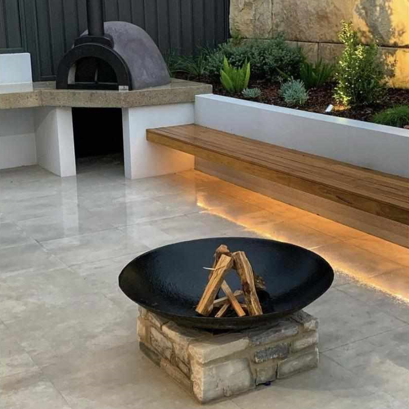 Cauldron 80cm Cast Iron Fire Pit in an outdoor entertainment space