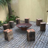 Cauldron Fire Pit in an outdoor area with log seats around it