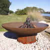 The Cauldron Cast Iron Fire Pit with kindling burning