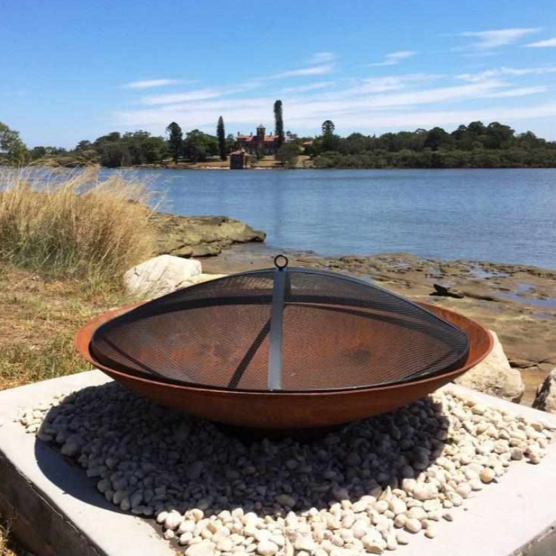 The Cauldron Cast Iron Fire Pit with a mesh cover