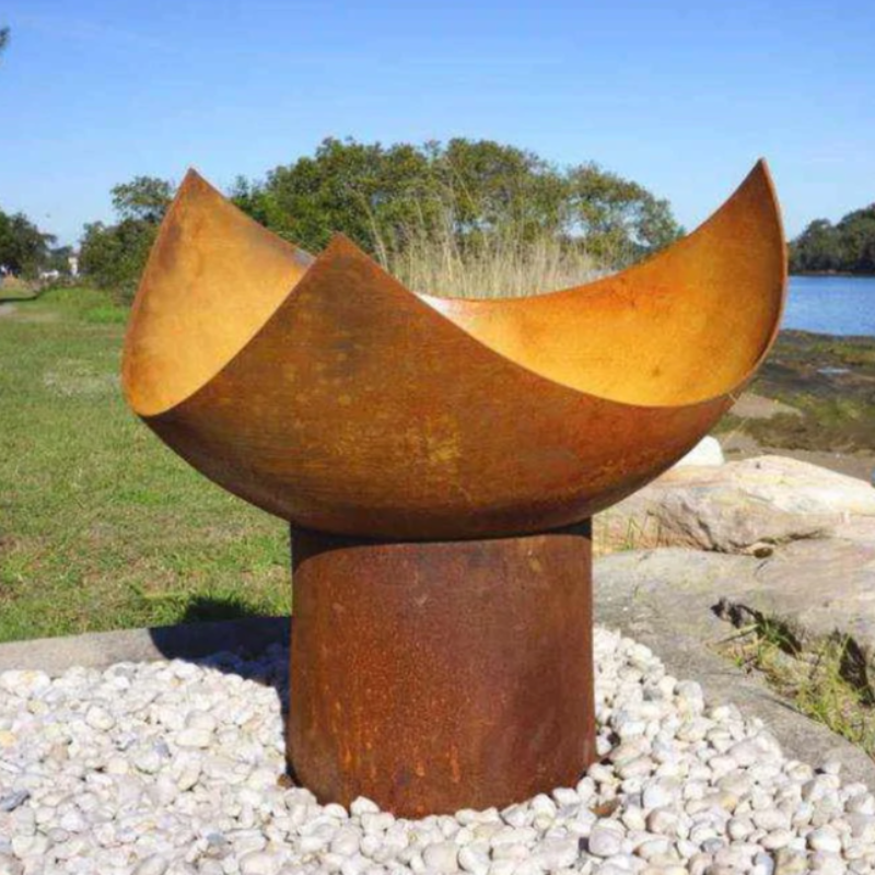 he Chalice Fire Pit in natural rust colour at the seaside 