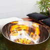 The Goblet Stainless Steel Fire Pit with small fire burning in garden setting