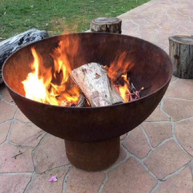 The Goblet Fire Pit with burning fire in garden