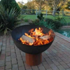 The Goblet Fire Pit with fire burning beside a pool