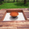 The Teppanyaki Fire Pit in backyard setting with lid on