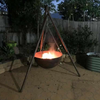 The Tripod Fire Pit in a backyard setting with fire burning