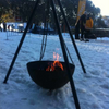 The Tripod Fire Pit in the snow with a burning fire