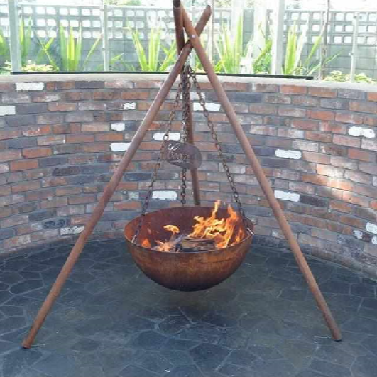 The Tripod Fire Pit set up in an outdoor fire pit space 