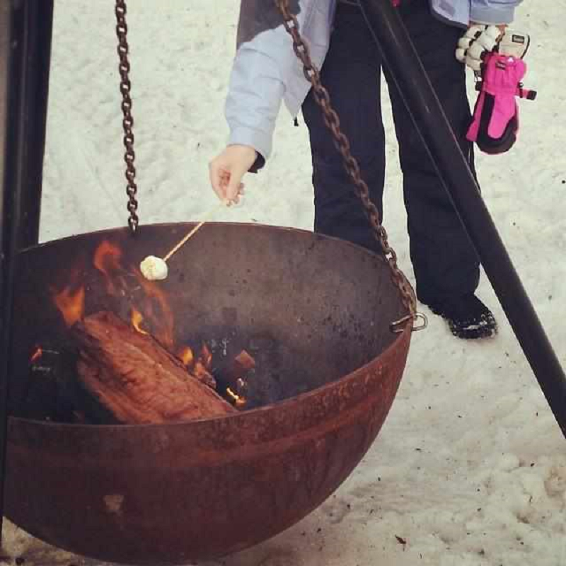 Toasting a marshmellow on the Tripod Fire Pit