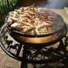 The Ultimate BBQ Fire Pit with sausages and chicken wings cooking