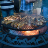 Cooking meat on the Ultimate BBQ Fire Pit