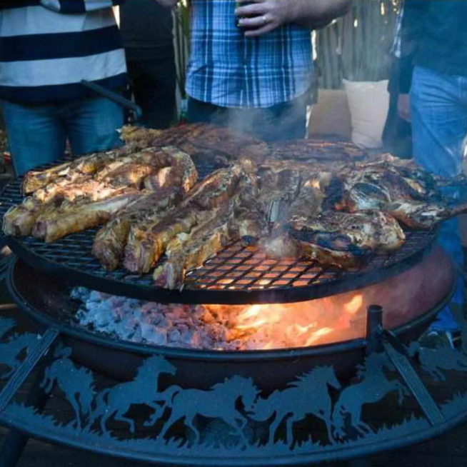 Cooking meat on the Ultimate BBQ Fire Pit